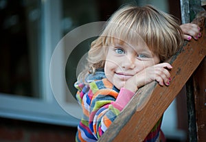 The Little girl on the porch of the village house