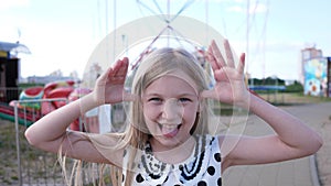 Little girl portrait grimaces in the park