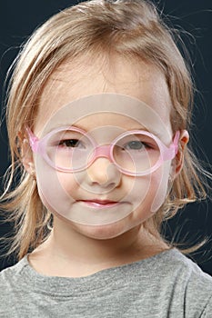 Little girl portrait in pink glasses