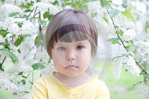 Little girl portrait in spring 4 years old, kindly smiling child toddler