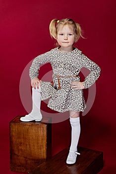 Little girl poses in front of the camera,