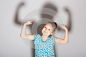 Little girl posing like a bodybuilder