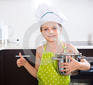 Little girl with pot at kitchen