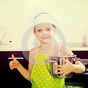 Little girl with pot at kitchen