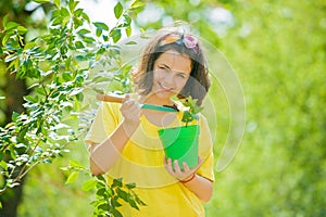 Little girl with pot. Lovely Child walking in spring garden. Child gardening in the backyard garden. Crop planting at