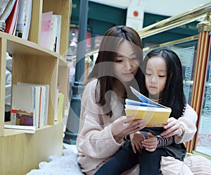 Little girl practice reading in the Brilliantly illuminated Market