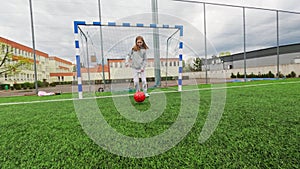 Little Girl Practicing With A Coach On A Soccer Field