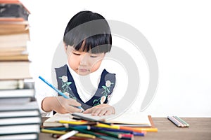 Little girl practicing writing in class