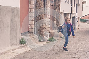 Little girl practising kicks on a street