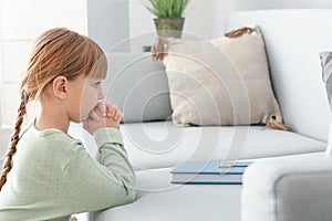 Little girl praying at home