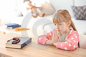 Little girl praying at home