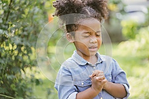 Little girl praying. kid prays. Gesture of faith.Hands folded in prayer concept for faith,spirituality and religion.