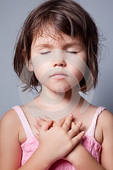 Little girl praying in lotus position