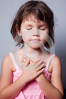 Little girl praying in lotus position