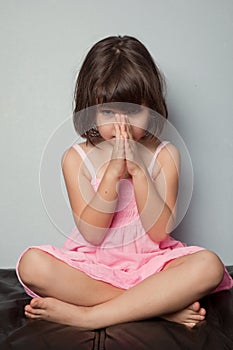 Little girl praying in lotus position