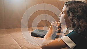 Little girl praying in the night. Little girl hand praying. little girl holy bible prays with bible lifestyle in her