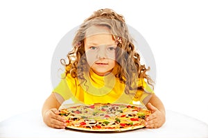 Little girl preparing homemade pizza