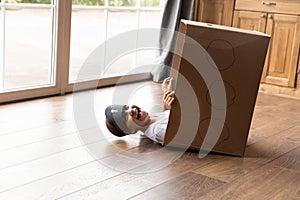 Little girl pretending pirate fall with laughter from cardboard box