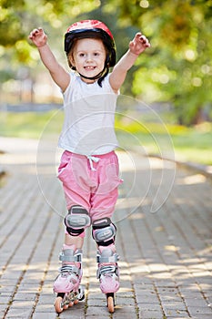 Little girl in protective equipment and rollers