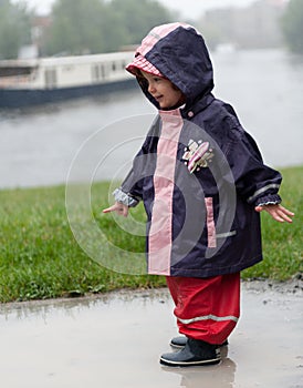 Little girl in a puddle