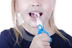 Little girl pull out a tooth with toy pliers on a white background