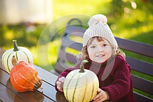 Little girl with pumpkin harvest, Thanksgiving.