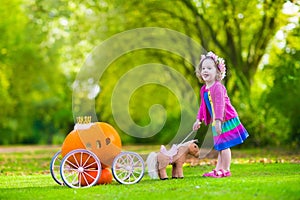 Little girl at pumpkin patch at Halloween