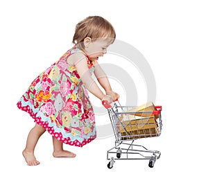 Little girl pushing a trolley