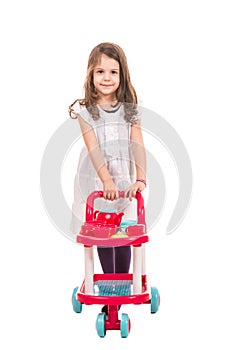 Little girl pushing trolley pram