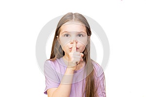 The little girl put her index finger to her mouth. Isolated on a white background.