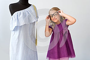 Little girl putting on glasses