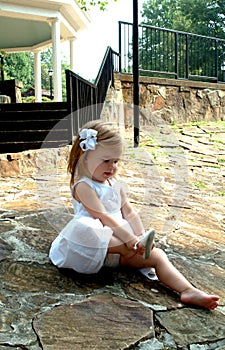 Little Girl Putting Shoes On