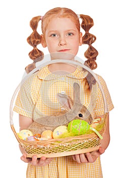Little girl with a rabbit in basket easter eggs