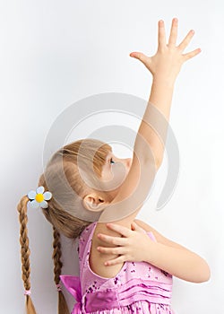 A little girl reaching for something