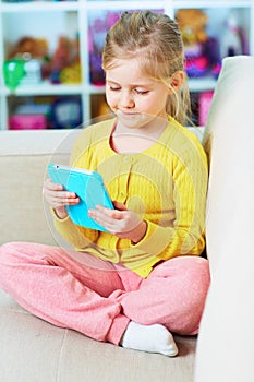 Little girl read book in tablet