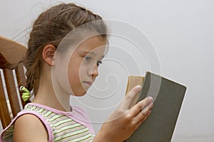 Little girl reading big book