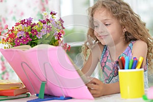 Little girl reading book