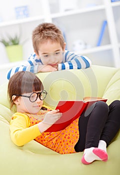 Little girl reading from book