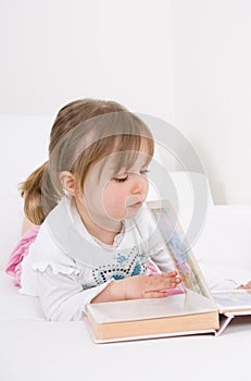 Little girl reading book