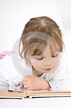 Little girl reading book