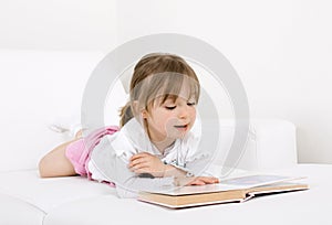 Little girl reading book