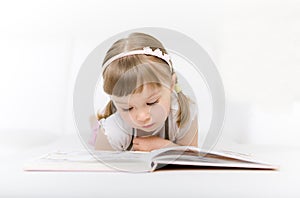 Little girl reading book