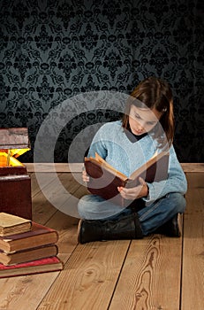 Little girl reading a book