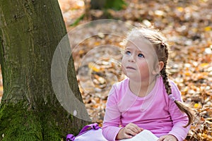 Little girl is reading a book