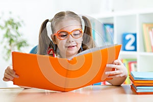 Little girl reading a book