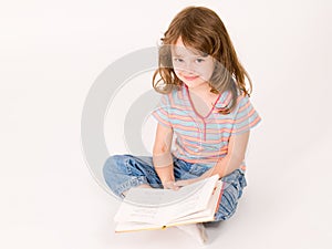 Little girl reading a book