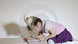 Little girl reading book with loupe