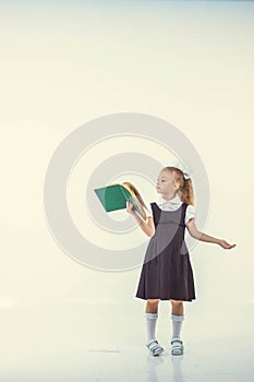 Little girl reading book, preparing for school