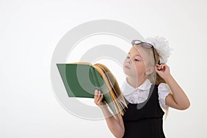 Little girl reading book, preparing for school