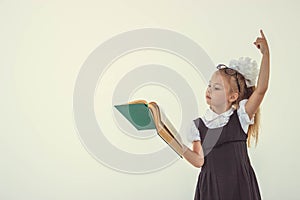 Little girl reading book, preparing for school